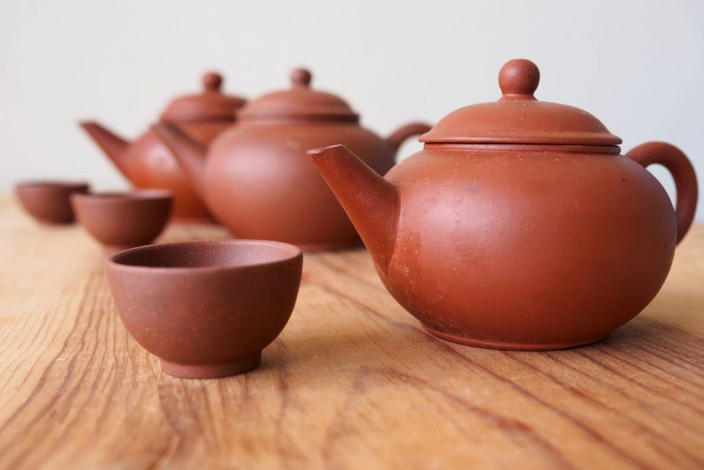 Chinese teapot and teacup on spruce wood