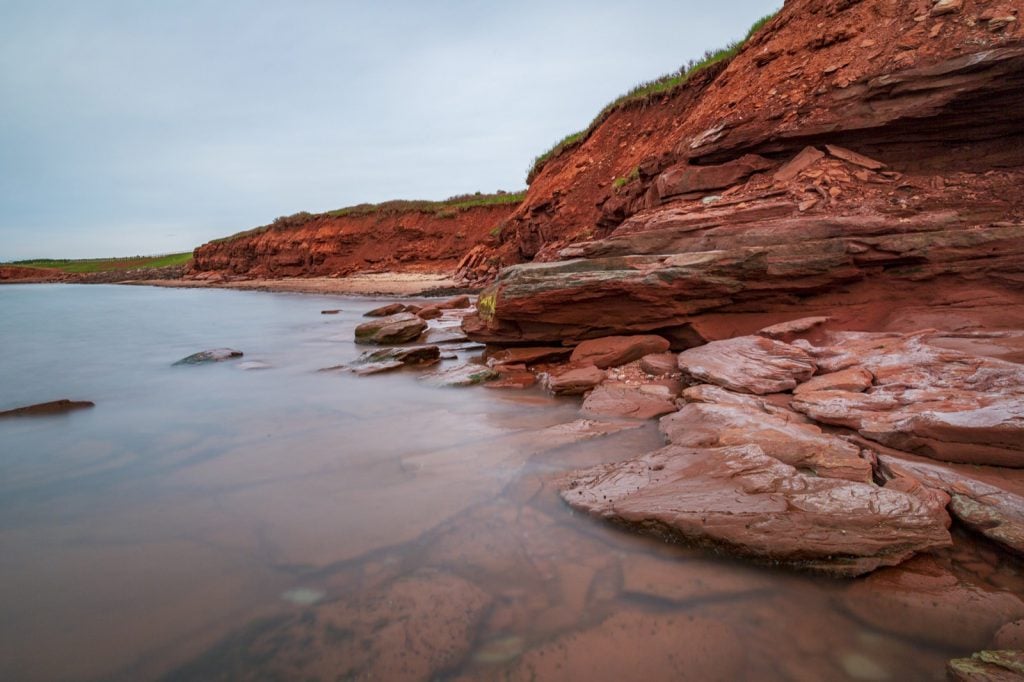 Red sandstone cliffs at Cavendish Beach on Prince Edward Island in Canada