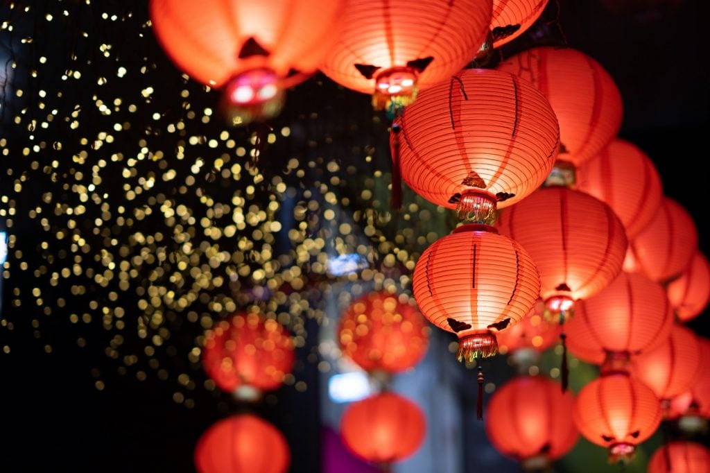 Chinese red lanterns and golden light in the night of Chinese New Year of happiness