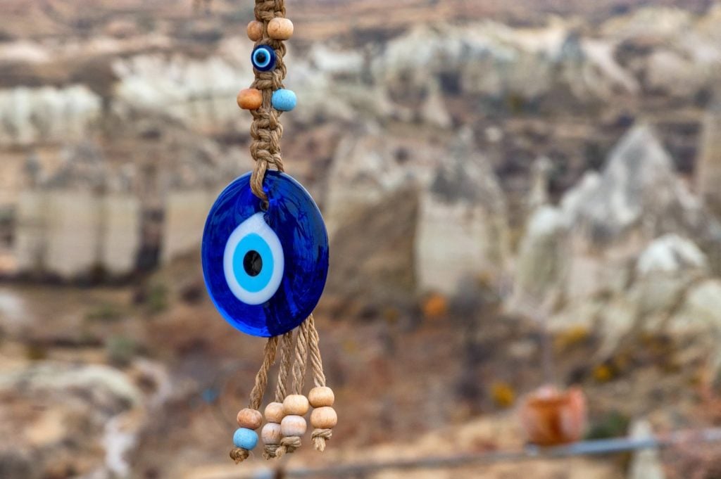 Close up of blue Nazar eye-shaped bead or amulet used to ward off evil and bring good luck in Pakistan