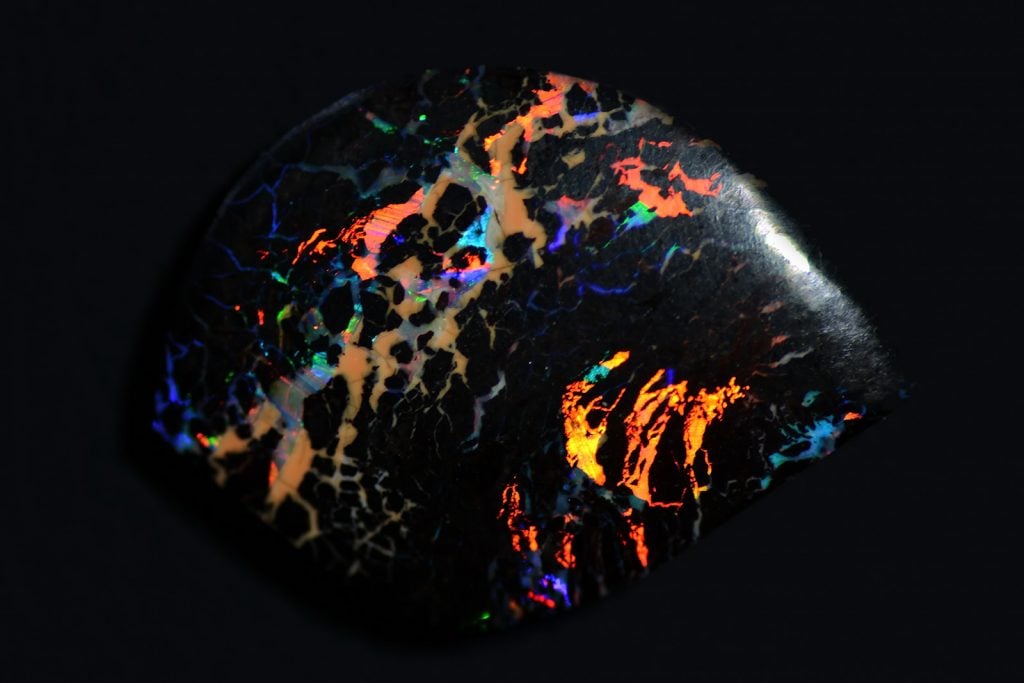 Colorful black opal on dark background