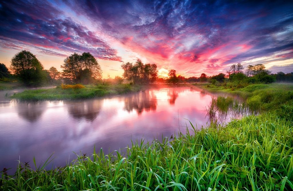 Colorful sunrise over river banks