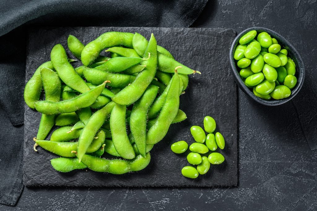 Top view of green edamame soy beans edamame on black background