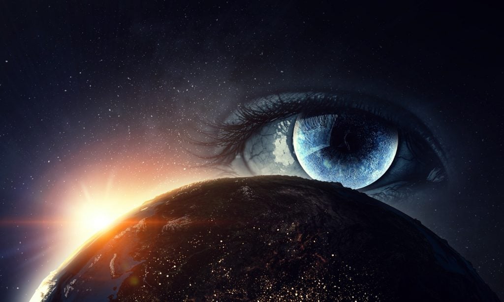 Eye seeing the world in color with the sun rising in the background