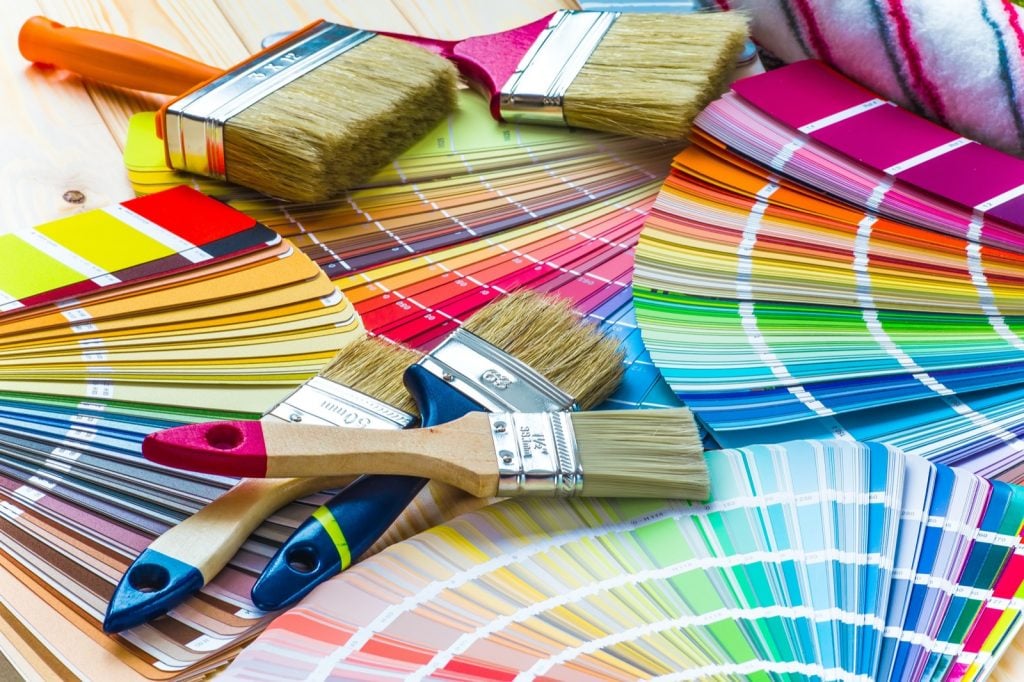 Interior wall painting work table with color swatches and brushes