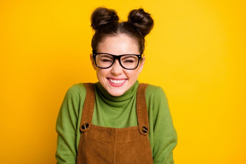 Closeup photo of happy giggling lady isolated on yellow background