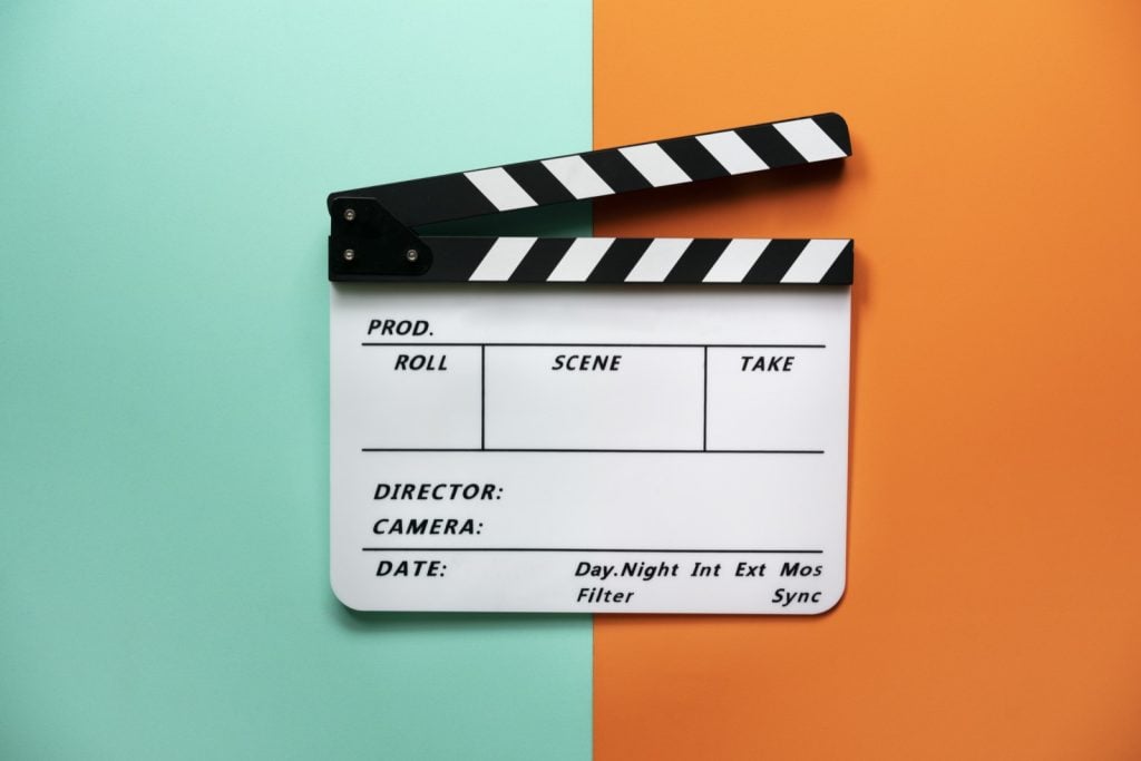 Movie clapper board on dual color table background