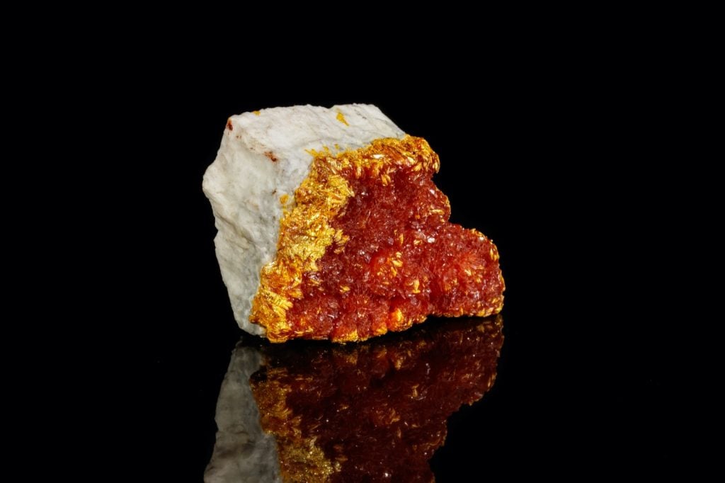 Orpiment mineral stone isolated on a black background