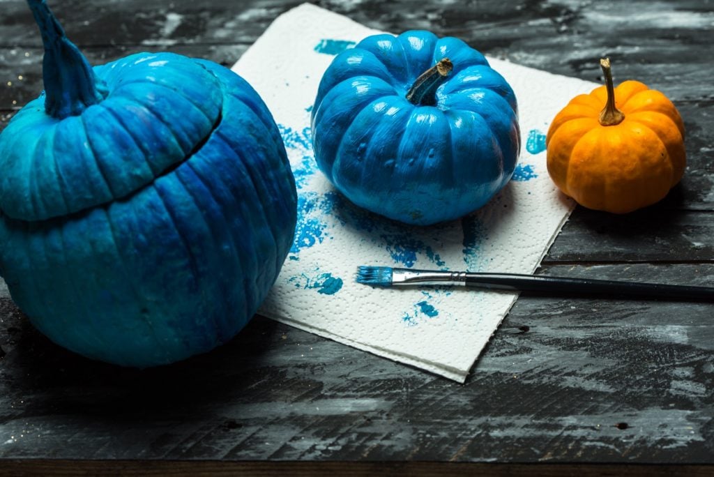 Painting Halloween pumpkins in a blue color
