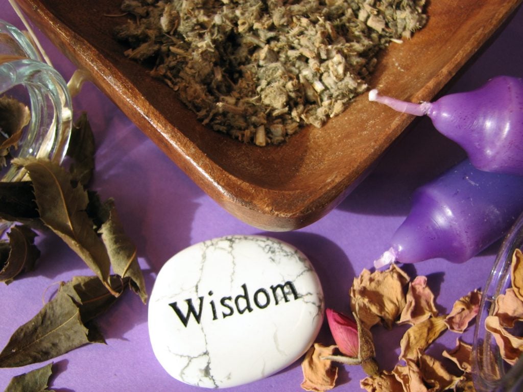 Purple candles on table meaning wisdom