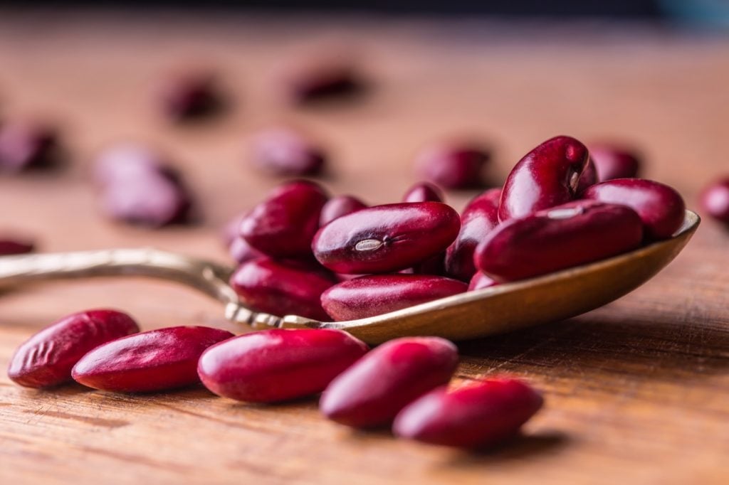 Red beans in a spoon on a table