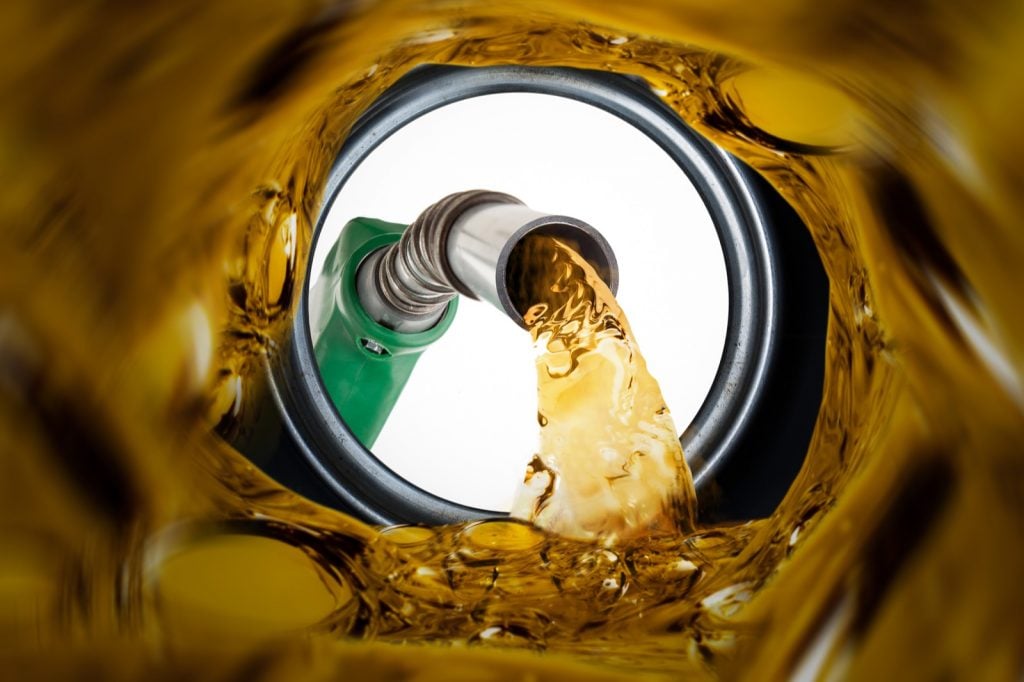 Refilling fuel with view inside gas tank of car