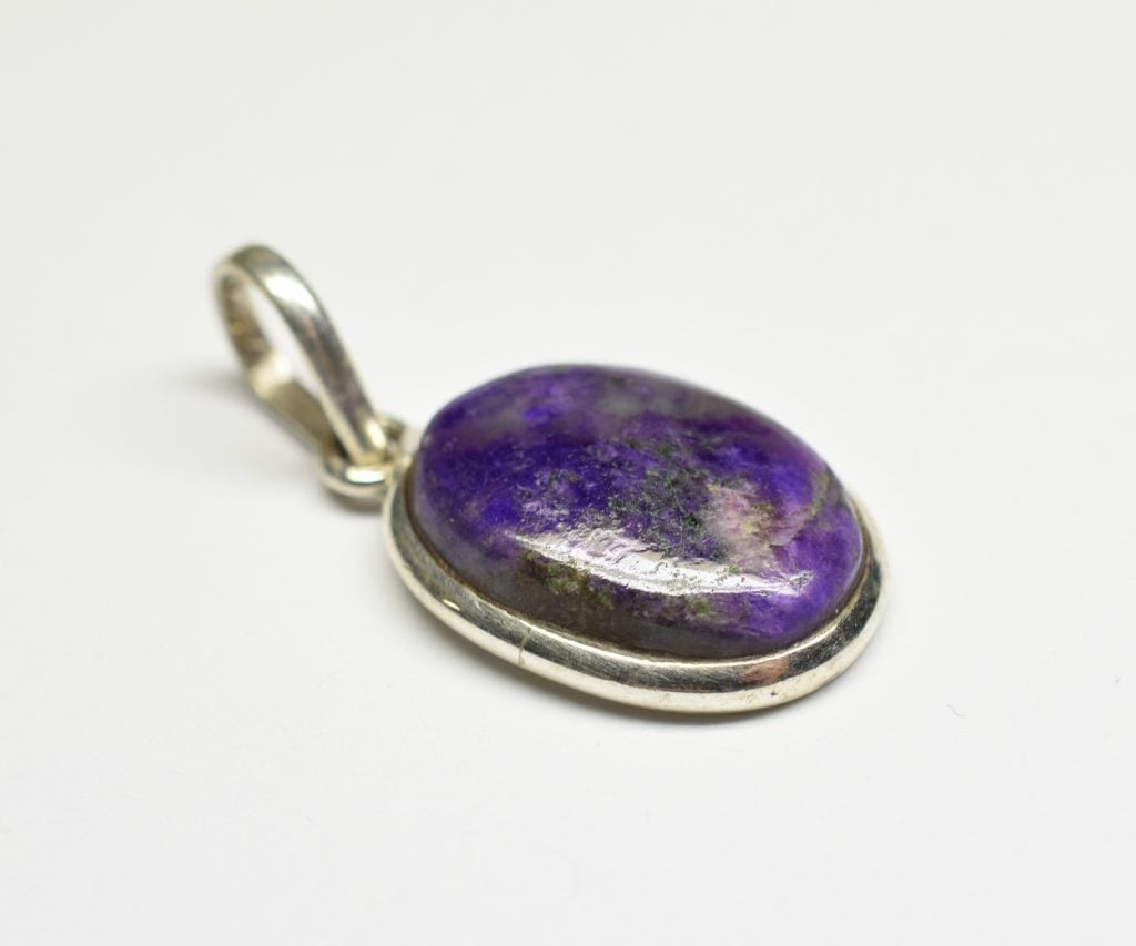 Close up of purple sodalite stone in a silver pendant