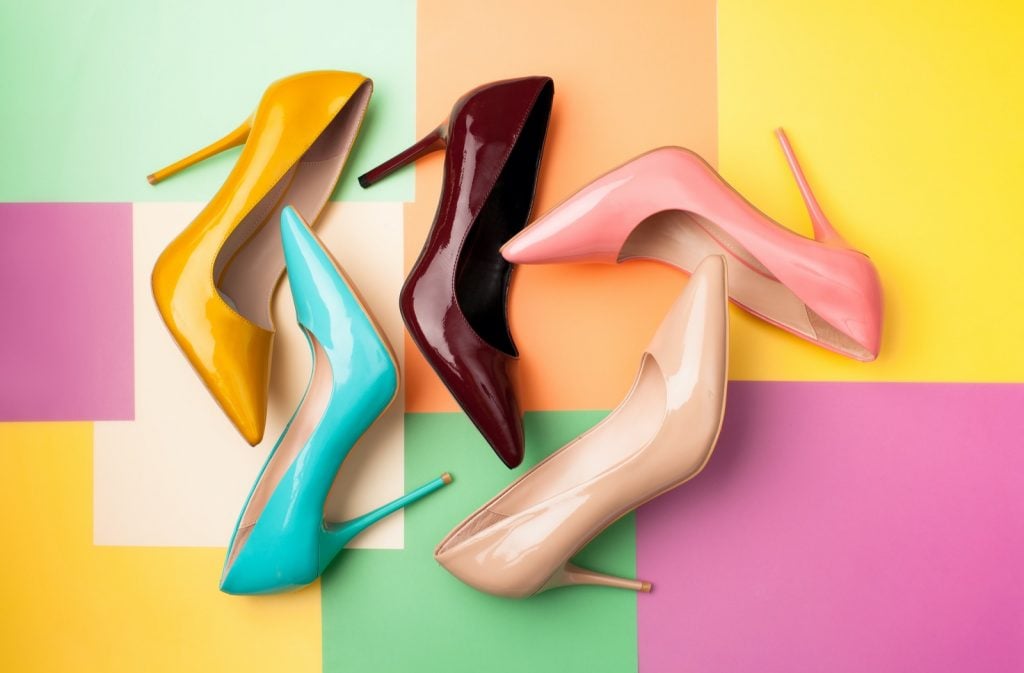 Set of bright colored women's shoes on a background with different colors