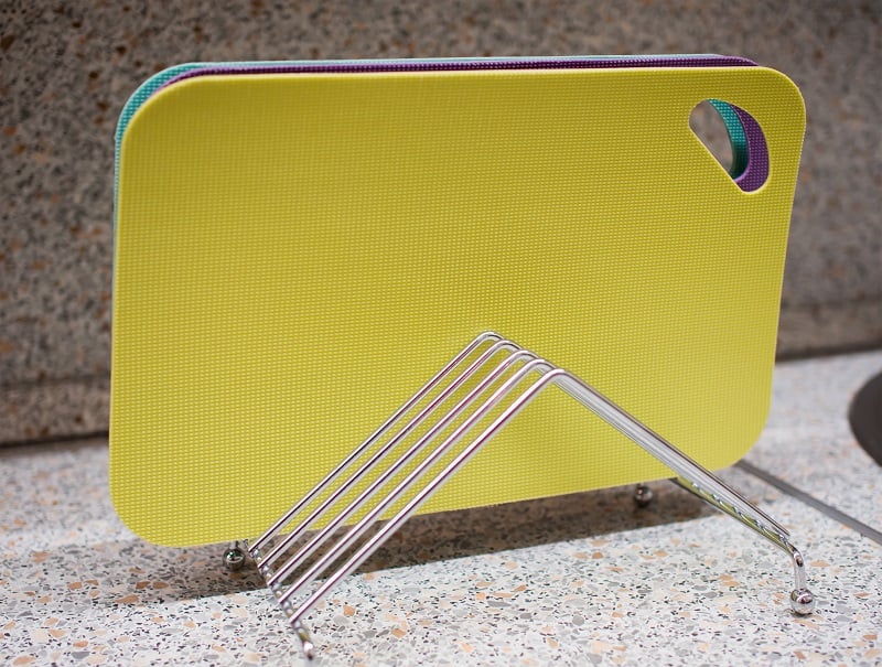 Set of multi-colored cutting boards on a metal stand